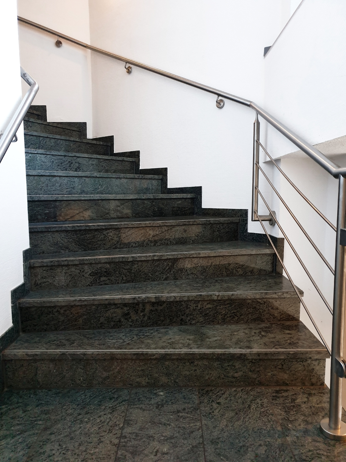 Modern staircase with black grey granite floor